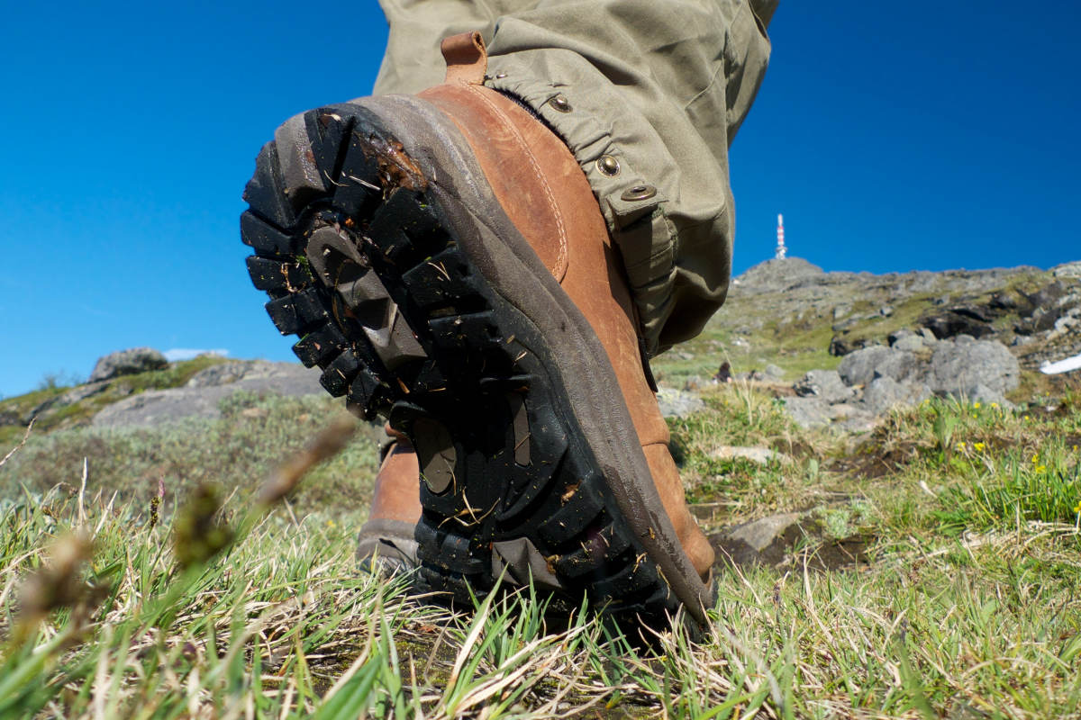 Male walker wearing modern walking boots on a hike